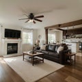 Beautiful living room interior with hardwood floors and fireplace in new luxury home Has view of kitchen hallway and loft area Royalty Free Stock Photo