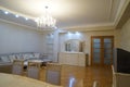 Beautiful living room interior with hardwood floors and fireplace roaring fire in new luxury home.