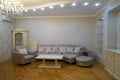 Beautiful living room interior with hardwood floors and fireplace roaring fire in new luxury home.