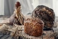 Beautiful loaves of bread on a leaven of white wheat on a plate on the edge of the canvas. Homemade cakes, handmade. Close up Royalty Free Stock Photo