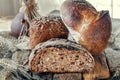 Beautiful loaves of bread on a leaven of white wheat on a plate on the edge of the canvas. Homemade cakes, handmade. Close up Royalty Free Stock Photo