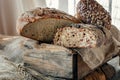 Beautiful loaves of bread on a leaven of white wheat on a plate on the edge of the canvas. Homemade cakes, handmade. Close up Royalty Free Stock Photo