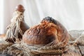 Beautiful loaves of bread on a leaven of white wheat on a plate on the edge of the canvas. Homemade cakes, handmade. Close up Royalty Free Stock Photo