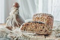 Beautiful loaves of wheat leaven bread with an assortment of grains and seeds on a plate on the edge of the canvas. Homemade cakes Royalty Free Stock Photo