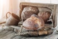 Beautiful loaves of wheat leaven bread with an assortment of grains and seeds on a plate on the edge of the canvas. Homemade cakes Royalty Free Stock Photo