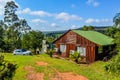 A beautiful log wooden cabin house in Sabie South Africa overlooking indigenous pine forest and greenery