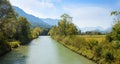 Beautiful Loisach river with green riversides and view to Zugspitze mountain Royalty Free Stock Photo