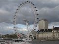 Beautiful London Eye over the water under a cloudy sky