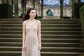 Beautiful lonely brunette girl with creative make-up stands waiting for someone