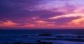 Beautiful long exposure shot over ocean at dusk just after sunset with red magenta gradient sky Royalty Free Stock Photo