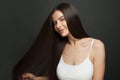 Beautiful long hair. Beauty woman with straight black hair on dark background Royalty Free Stock Photo