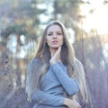 Beautiful long hair blonde woman touching her face. Outdoor fashion portrait Royalty Free Stock Photo