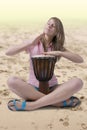 Djembe drummer playing on the beach