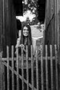 Beautiful long haired girl near the wooden fence in the village. Royalty Free Stock Photo