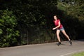 Beautiful long legged girl roller skating in park Royalty Free Stock Photo