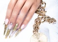 Beautiful long nails in a gold design with Royalty Free Stock Photo