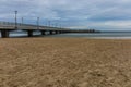 Beautiful long water pier over Baltic sea at cloudy stormy day