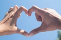 Beautiful Love shape hands - heart on blue sky Royalty Free Stock Photo