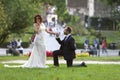 Stylish bride and groom at a park on their wedding day. Beautiful love story in nature, couple in love Royalty Free Stock Photo