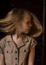 Beautiful lovely little blonde girl with different emotions on a dark background Royalty Free Stock Photo