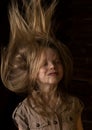 Beautiful lovely little blonde girl with different emotions on a dark background Royalty Free Stock Photo