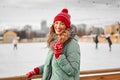 Beautiful lovely middle-aged girl with curly hair warm winter jackets stands ice rink background Town Square