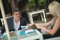 Beautiful, lovely, young couple discussing news in restaurant. Royalty Free Stock Photo