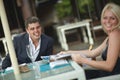 Beautiful, lovely, young couple discussing news in restaurant. Royalty Free Stock Photo