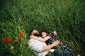Beautiful loving couple lying on poppies field background Royalty Free Stock Photo