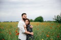 Beautiful loving couple resting on poppies field background Royalty Free Stock Photo