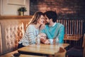 Beautiful loving couple sitting in a cafe drinking coffee and conversating Royalty Free Stock Photo