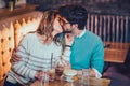 Beautiful loving couple sitting in a cafe drinking coffee and conversating Royalty Free Stock Photo