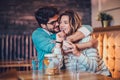 Beautiful loving couple sitting in a cafe drinking coffee and conversating Royalty Free Stock Photo