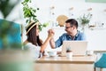 Beautiful loving couple sitting in a cafe enjoying in coffee and conversation