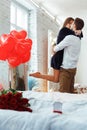 Beautiful loving couple is spending time together at home Attractive young woman in dress and handsome man hugging and love each Royalty Free Stock Photo