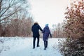 Beautiful loving couple walking in winter forest together. People having fun outdoors Royalty Free Stock Photo