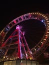 Beautiful low angle view of famous Ferris wheel with colorful rim in the dark at park Prater in Vienna, Austria. Royalty Free Stock Photo