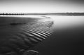 Beautiful low tide beach vibrant sunrise in black and white Royalty Free Stock Photo