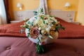 Beautiful lush wedding bouquet on bed in bride`s bedroom