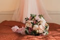 Beautiful lush wedding bouquet of pink flowers and bride's garter Royalty Free Stock Photo