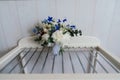 Beautiful lush wedding bouquet white peonies and blue flowers in room