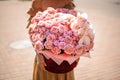 Huge luxurious bouquet of pink flowers in woman hands