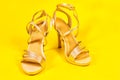 Beautiful luxurious vintage evening elegant women's sandals with rhinestones, high heels, on a yellow background Royalty Free Stock Photo