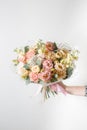 Beautiful luxury bouquet of mixed flowers in woman hand. the work of the florist at a flower shop Royalty Free Stock Photo