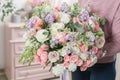 Beautiful luxury bouquet of mixed flowers in woman hand. the work of the florist at a flower shop. Royalty Free Stock Photo