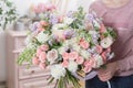 Beautiful luxury bouquet of mixed flowers in woman hand. the work of the florist at a flower shop. Royalty Free Stock Photo