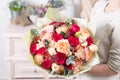 Beautiful luxury bouquet of mixed flowers in woman hand. the work of the florist at a flower shop. Royalty Free Stock Photo