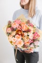 Beautiful luxury bouquet of mixed flowers in woman hand. the work of the florist at a flower shop. A small family Royalty Free Stock Photo