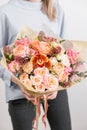 Beautiful luxury bouquet of mixed flowers in woman hand. the work of the florist at a flower shop. A small family Royalty Free Stock Photo