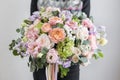 Beautiful luxury bouquet of mixed flowers in woman hand. the work of the florist at a flower shop. A small family Royalty Free Stock Photo